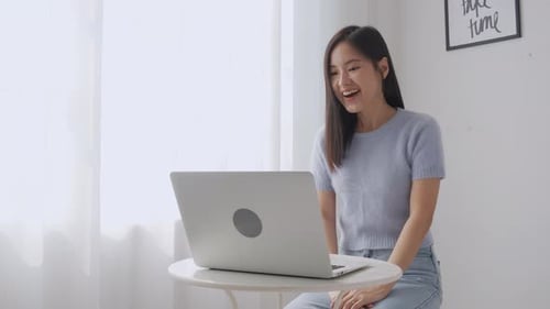 Smiling Woman Video Calling on Laptop Indoors