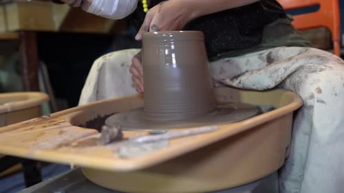 People Creating Pottery in Studio. Female artisan creating handmade ceramics in pottery workshop