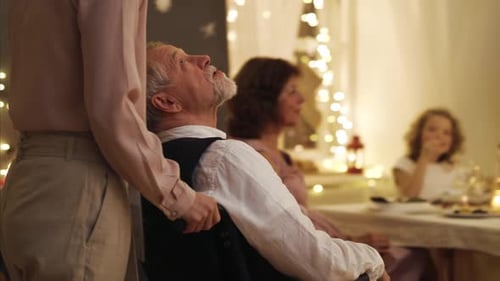 Family Celebration with Senior Man in Wheelchair