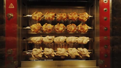 Tasty Chicken in Rotisserie Grill Machine at Restaurant