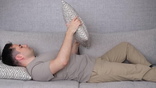 Bored Man Playing Pillow