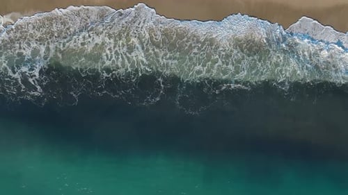 Aerial View Textured Patterns of Waves and Sand Create a Mesmerizing Beach Landscape Under the