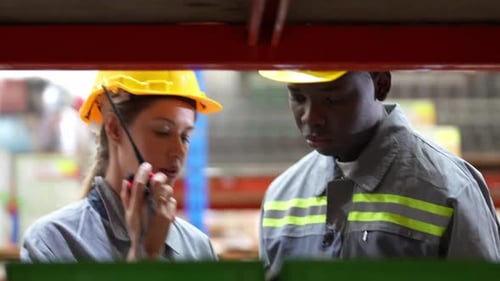 Warehouse Industrial and Logistics Companies. Dispatcher in uniform making inventory in storehouse.