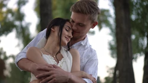 Loving Couple Embracing in a Sunny, Natural Setting