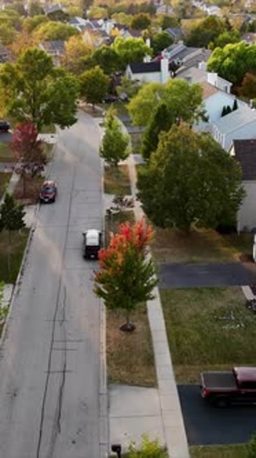 Aerial View of Suburban Neighborhood with Treelined Streets and Houses A Peaceful Aerial View