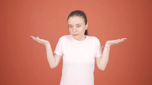 Woman gesturing with confusion in studio