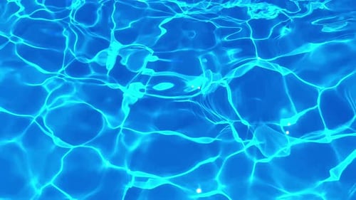Sunlit Ripples on a Blue Pool Surface