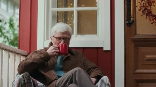 Senior Man Relaxing on Porch with Coffee