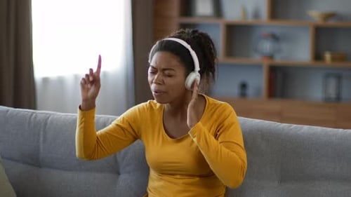 Woman Singing Along to Music on Couch