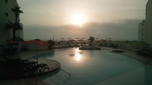 Soothing Calm Sunset Swimming Pool at Golden Hour Drone Wide View
