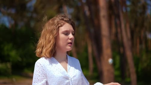 Woman Singing Outside in Forest
