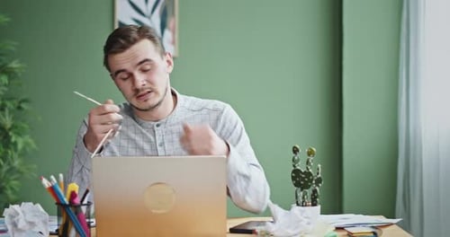 Exhausted Freelancer Tired From Work and Closes Laptop at Office Room