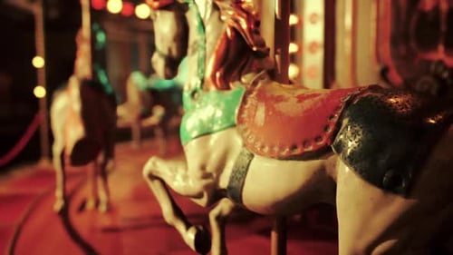 Empty Amusement Park at Night Featuring Quiet Carousel and Bright Lights