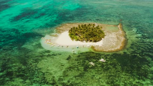 Tropical Guyam Island with a Sandy Beach and Tourists