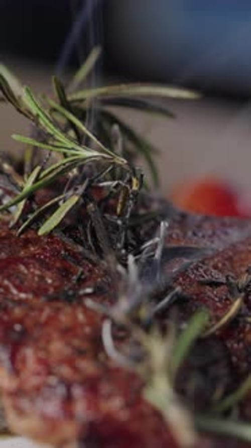 Close Up Grilled Steak with Rosemary Smoke