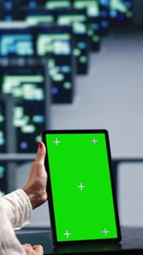 Woman Holding Tablet With Green Screen in Studio