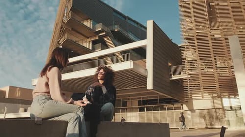 Students emotionally share the news and laugh while sitting next to the university