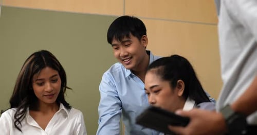 Young workers having fun during business meeting in office