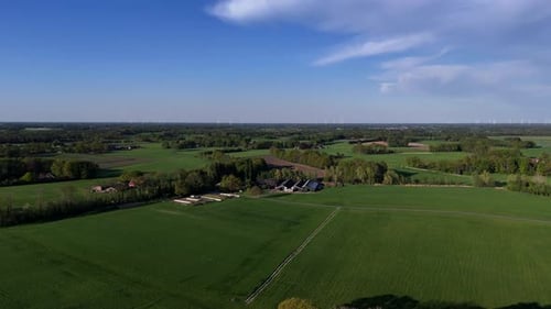 Farmers house with stable and barn in american countryside. Blue sky with sunlight in spring. Green