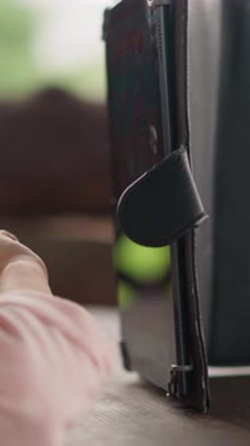 Little Girl in Pink Jacket Presses Keys on Tablet Screen