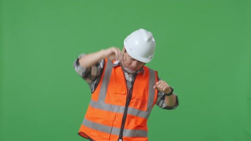 Asian Male Engineer With Safety Helmet Screaming Goal And Dancing Celebrating In The Green Screen