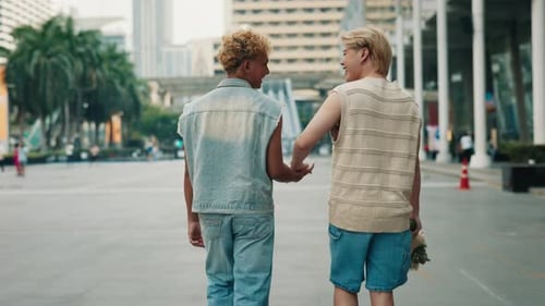 Asian Gay Couple In Love Holding Hands Walking with Flowers in the City