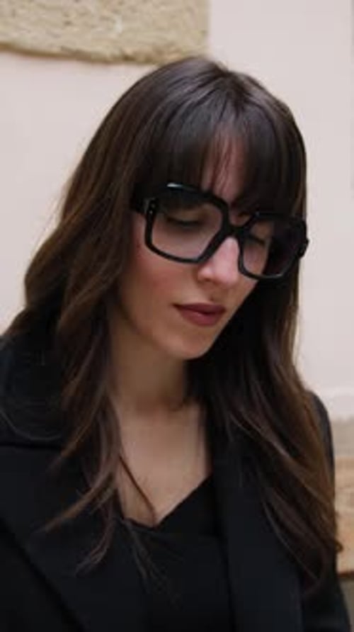 Stylish Woman with Glasses Posing Outdoors