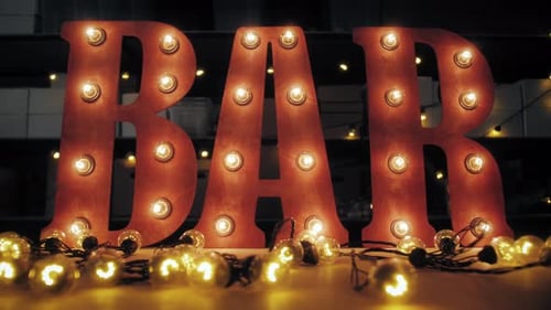 Light Bulb Glowing Letter on Factory Warehouse