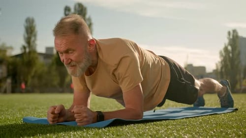 Caucasian Old Man in Plank Exercise Workout Training Stadium City Outside Effort Strain Fitness