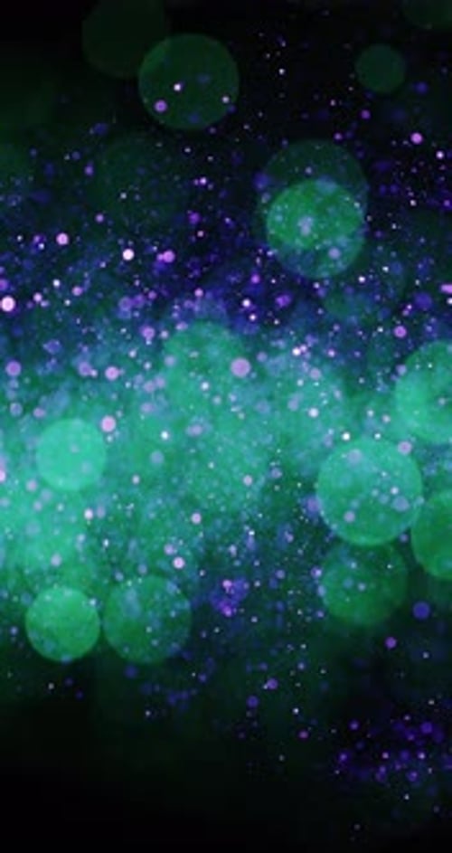 Particles In Colors Violet And Green Drifting In The Dark
