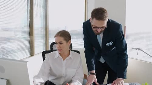 Office Meeting with a Man and Woman Discussing Work