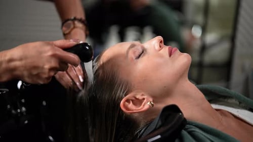 Blonde Woman Getting Hair Washed at Salon
