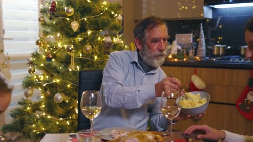 Family celebrates Christmas together at the dinner table