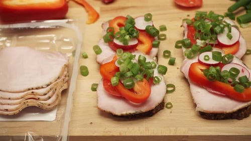 Colorful Ham Sandwiches with Vegetables on Wood Board