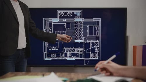 An Unrecognizable Woman Makes a Presentation of an Architectural Project in a Design Studio House