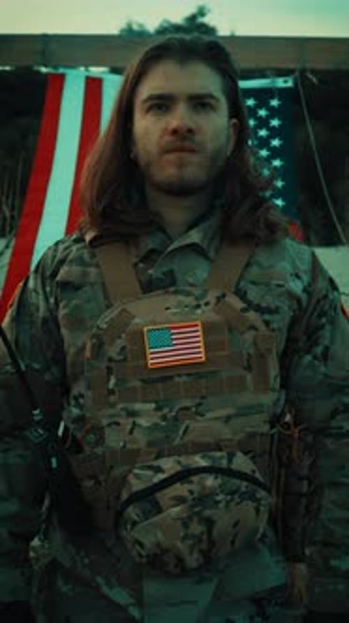 Man in Camo Saluting American Flag