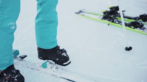 Person fastens the ski boots before skiing