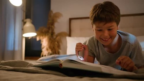 Happy Cute Focused Caucasian Boy Child Little Schoolboy Reading Book Story Literature Kid Son Lying