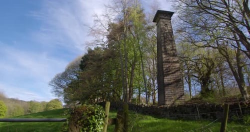 Stone Tower in Green Rural Landscape During Day