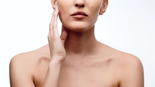 Woman Gently Touches Face and Neck