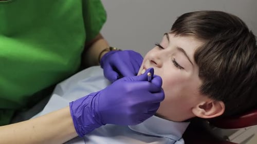 Child Receives Dental Exam in a Hospital