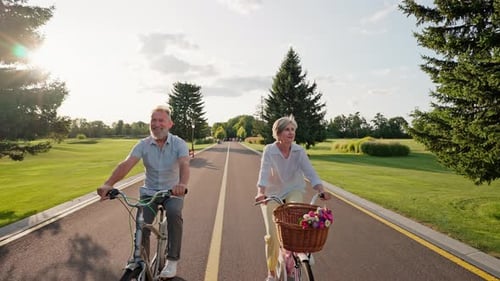 Elder Active Couple Riding Bicycles in National Park