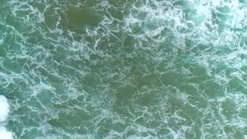 Top Down Aerial View of Giant Ocean Waves Crashing and Foaming