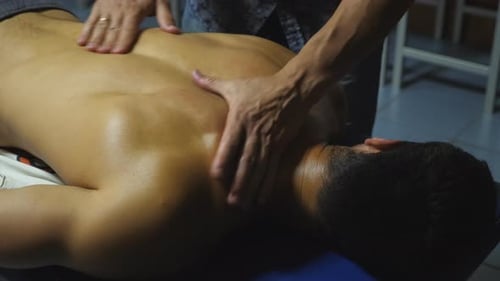 Close Up to Hands of Masseur Massaging Shoulders of Sportsman in Salon Male Arms of Professional