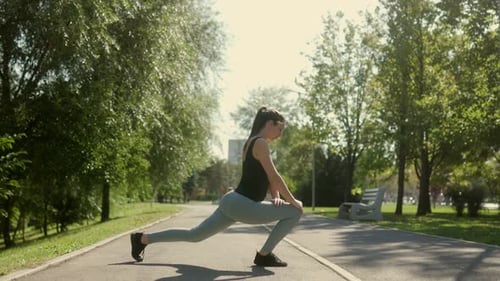 Caucasian Woman Training Outdoors in a Park Enjoying a Healthy Lifestyle
