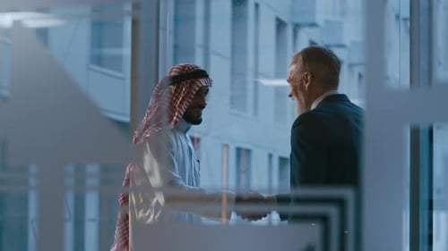 Diverse Executives Discussing Business by Panoramic Windows at Office
