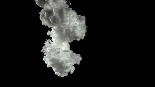 White cloud of ink slowly descending on black background