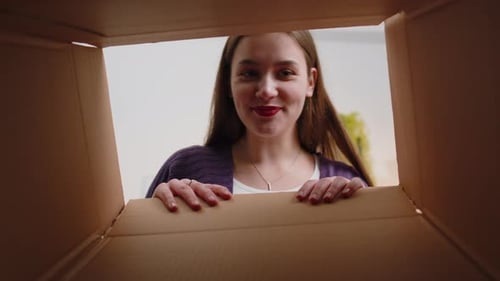 Happy Young Woman Shopper Unpacking Cardboard Box Delivery Parcel Online Shopping Purchase at Home