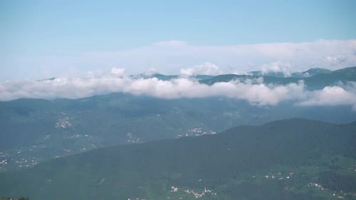 Clouds and trees on the mountain in foggy weather time lapse 4K
