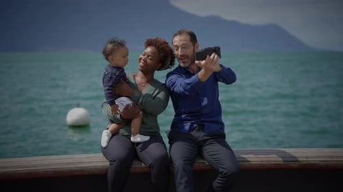Happy Family Posing for Photo By Lake